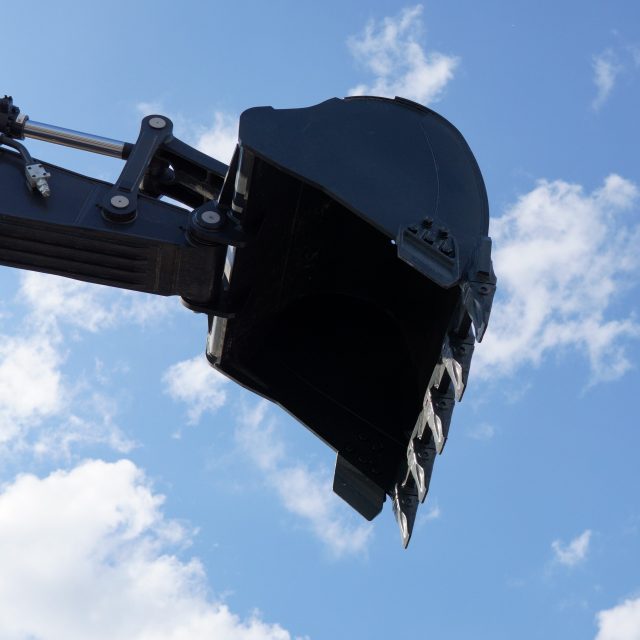 An excavator arm with an excavator bucket.